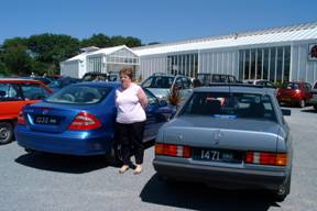 Denise with one of our cars, looking at another one.